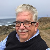 Smiling older man with glasses at beach